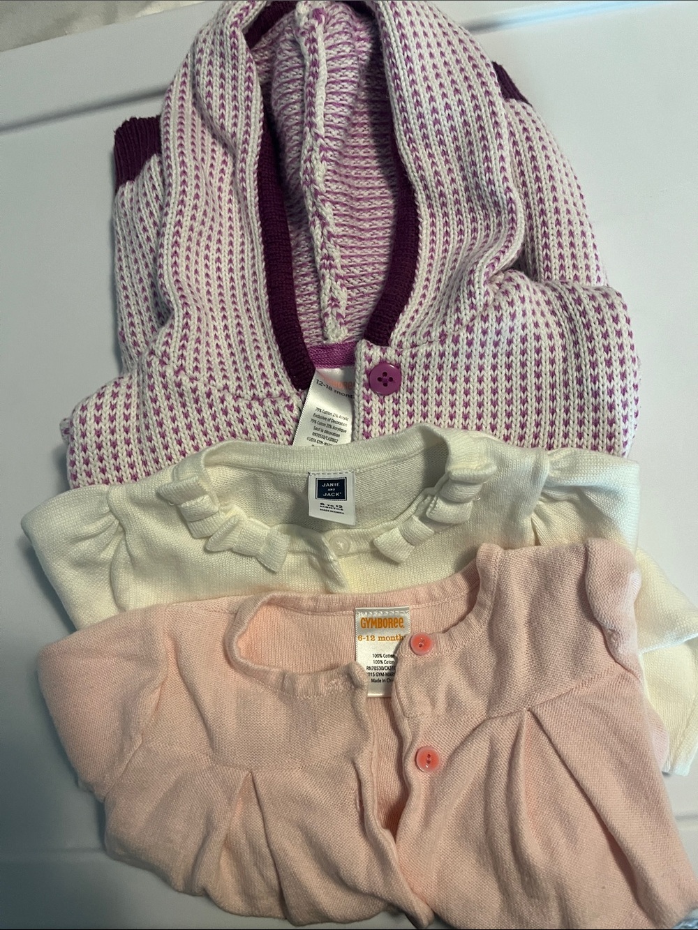 3 sweaters size 12 months one is a hoodie style and 2 cardigans